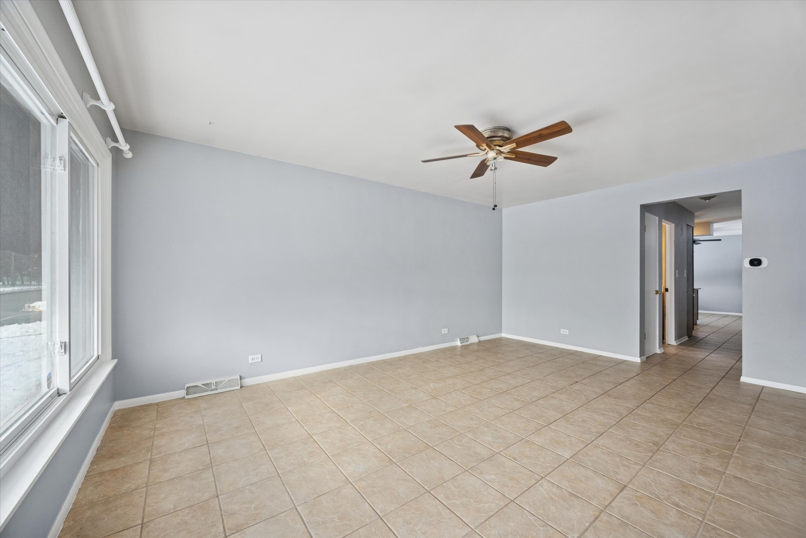 6718 41st Street Stickney, IL 60402 - Photo 3 of 15 wooden floor in an empty room with a ceiling fan
