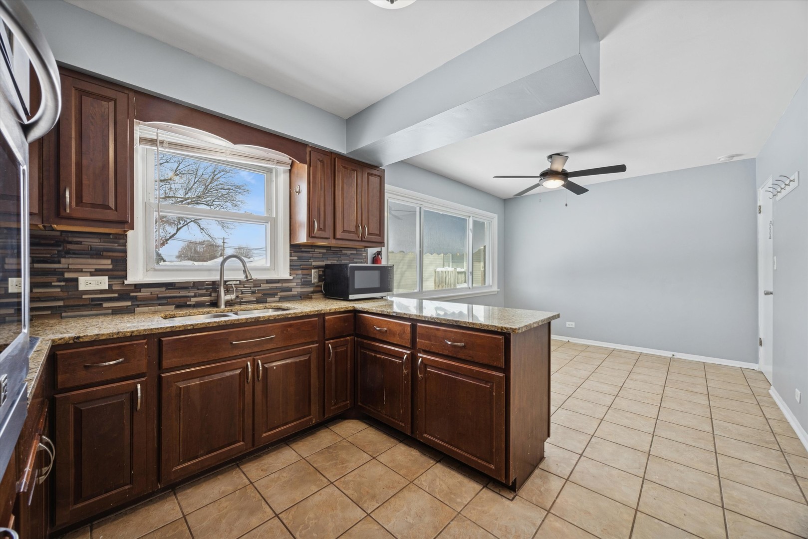 6718 41st Street Stickney, IL 60402 - Photo 8 of 15 a kitchen with a sink window and cabinets