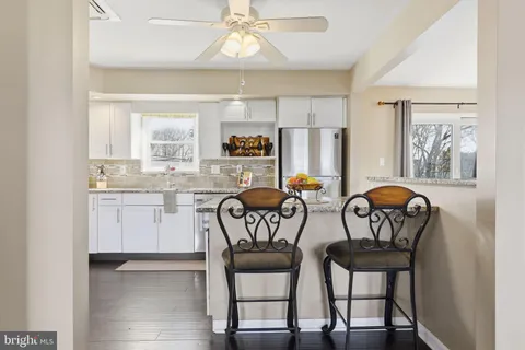 a view of a dining room with furniture and chandelier