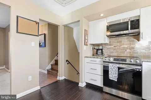 a kitchen with a stove and a microwave