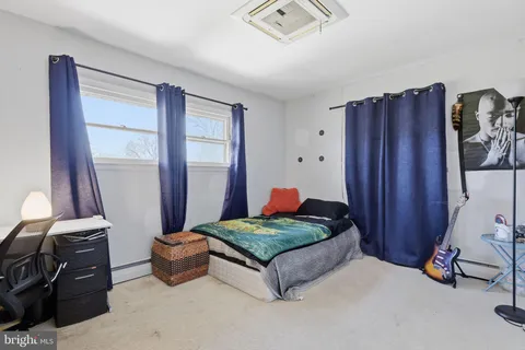 a living room with furniture and a dresser
