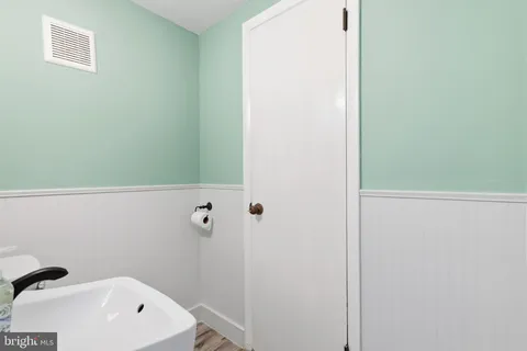 a bathroom with a white tub and shower