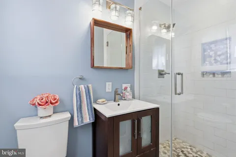 a bathroom with a sink vanity and a mirror