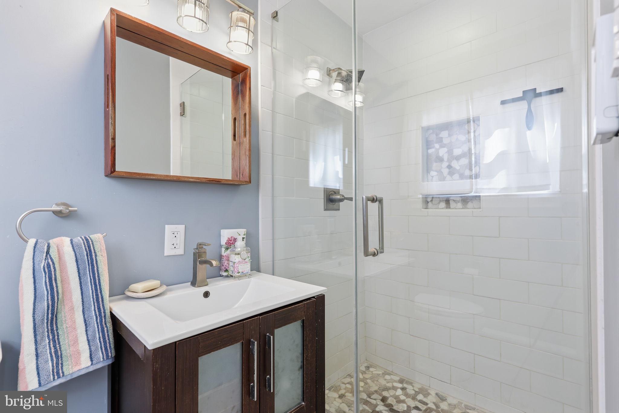 5 Patrick Lane Yardley, PA 19067 - Photo 29 of 51 a bathroom with a sink a mirror a vanity and shower