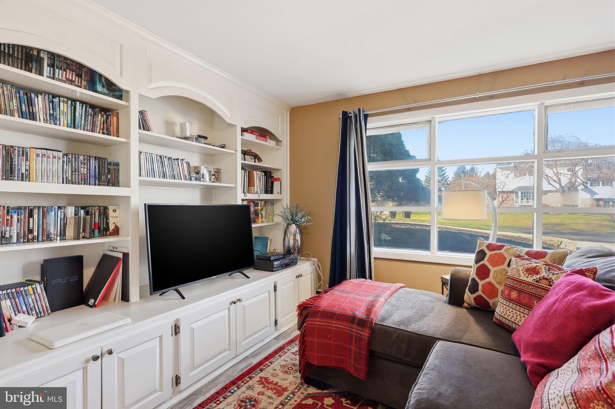 5 Patrick Lane Yardley, PA 19067 - Photo 32 of 51 a living room with furniture a flat screen tv and a floor to ceiling window