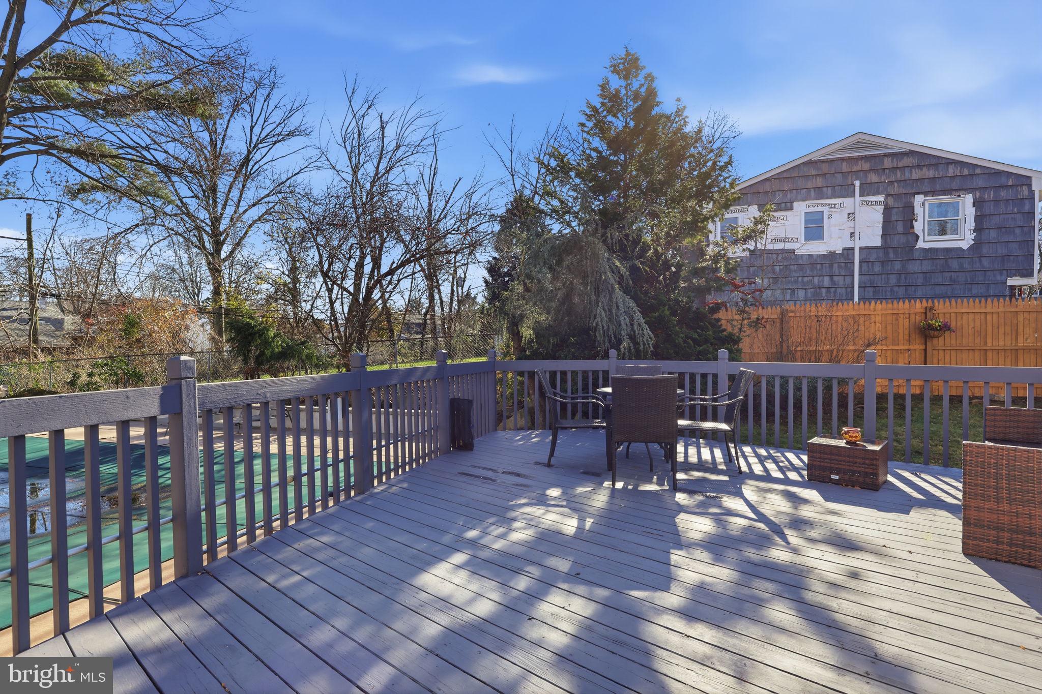 5 Patrick Lane Yardley, PA 19067 - Photo 35 of 51 a view of a roof deck with table and chairs with wooden floor and fence