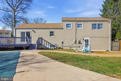 a view of a house with a yard and deck