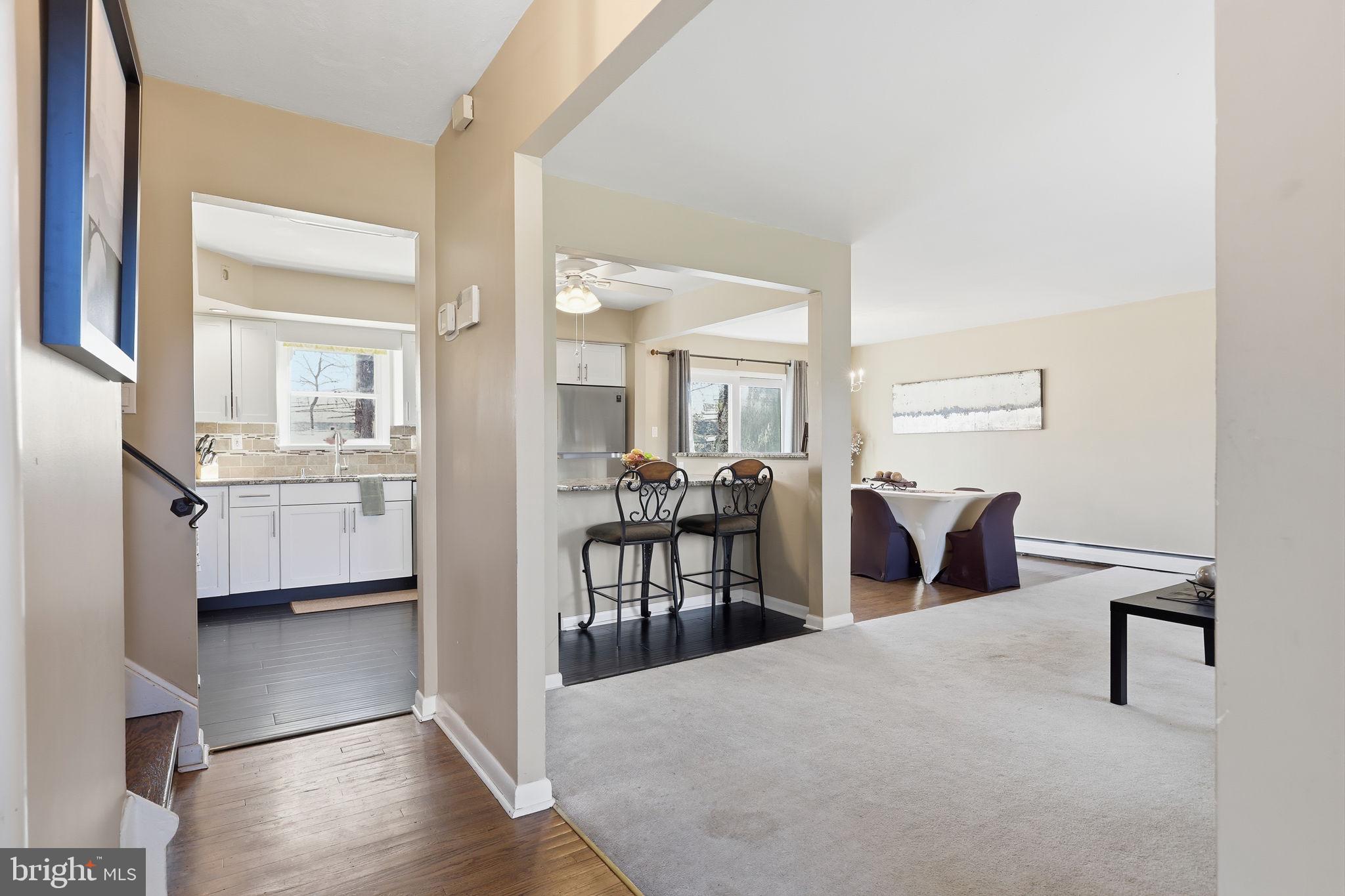 5 Patrick Lane Yardley, PA 19067 - Photo 5 of 51 a living room with furniture a table and kitchen view
