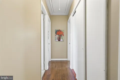 a view of a hallway with wooden floor