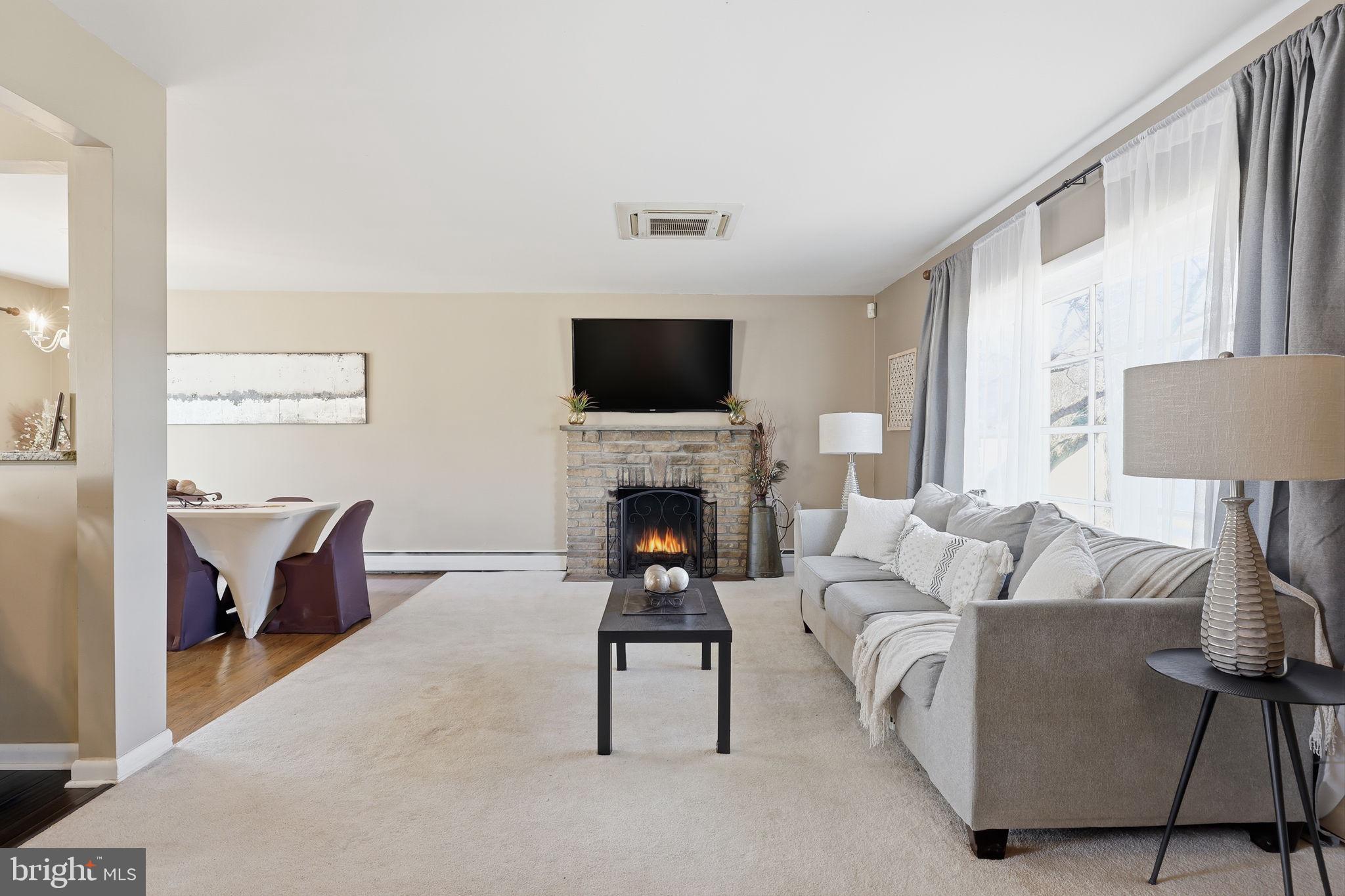 5 Patrick Lane Yardley, PA 19067 - Photo 7 of 51 a living room with furniture a fireplace and a flat screen tv