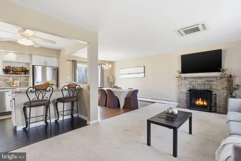 a living room with furniture a fireplace and a flat screen tv