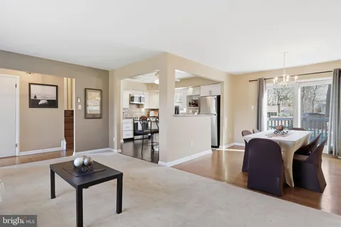 a living room with furniture a table and a large window