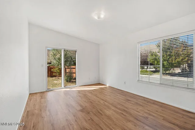 a kitchen with stainless steel appliances granite countertop a stove a refrigerator a sink dishwasher and wooden cabinets with wooden floor