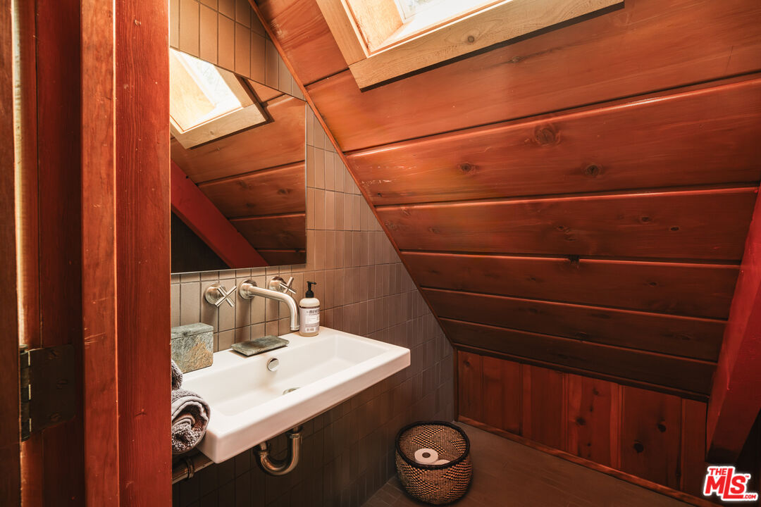 26955 Meadow Glen Drive Idyllwild, CA 92549 - Photo 24 of 57 a bathroom with a sink a toilet and mirror