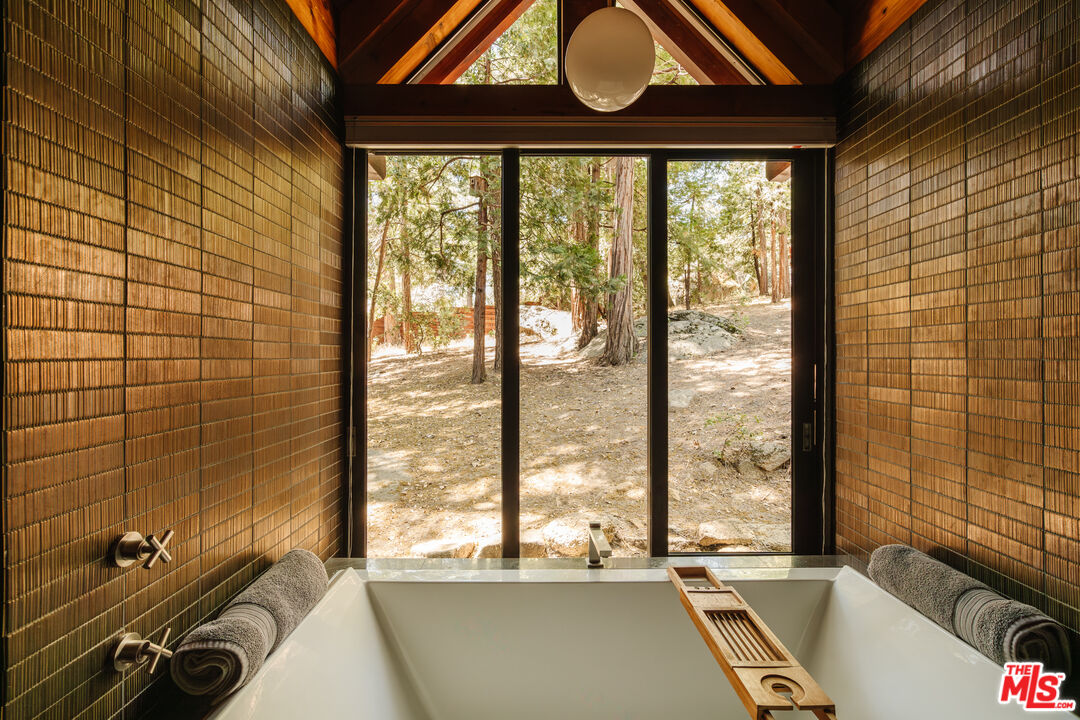 26955 Meadow Glen Drive Idyllwild, CA 92549 - Photo 29 of 57 a view of a bathroom with a tub and large window