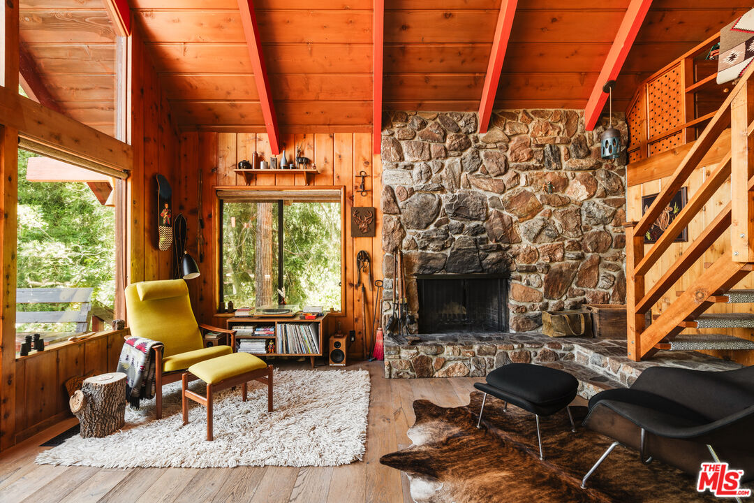 26955 Meadow Glen Drive Idyllwild, CA 92549 - Photo 5 of 57 a living room with furniture a fireplace and large windows