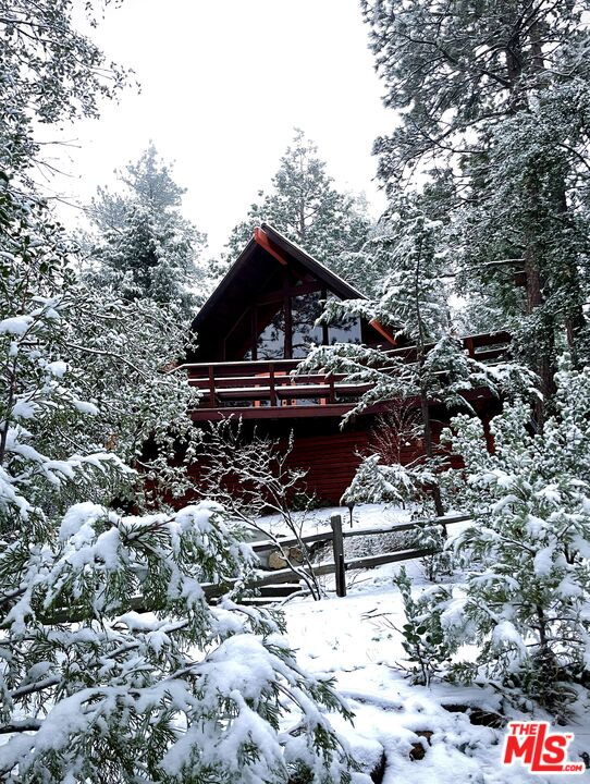 26955 Meadow Glen Drive Idyllwild, CA 92549 - Photo 54 of 57 a roof deck with table and chairs under an umbrella