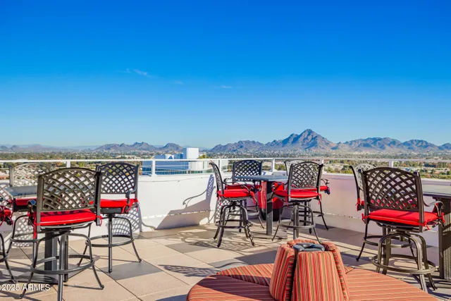 an outdoor sitting area with furniture and wooden floor