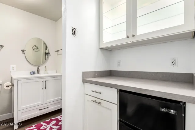 a kitchen with white cabinets and a stove