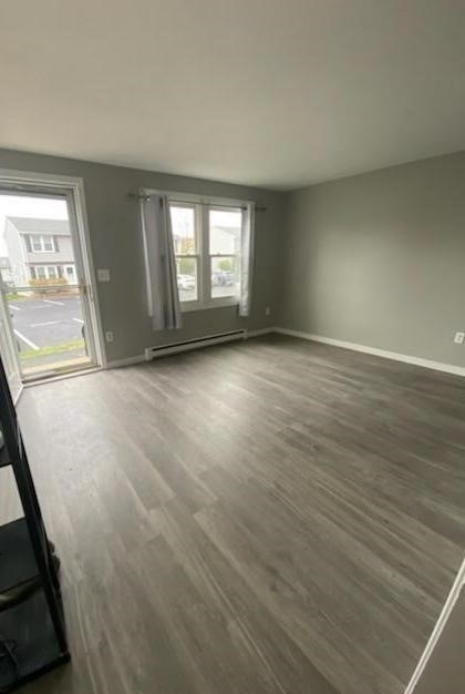 270 Sunderland Road, Unit 37 Worcester, MA 01604 - Photo 6 of 17 an empty room with wooden floor and windows