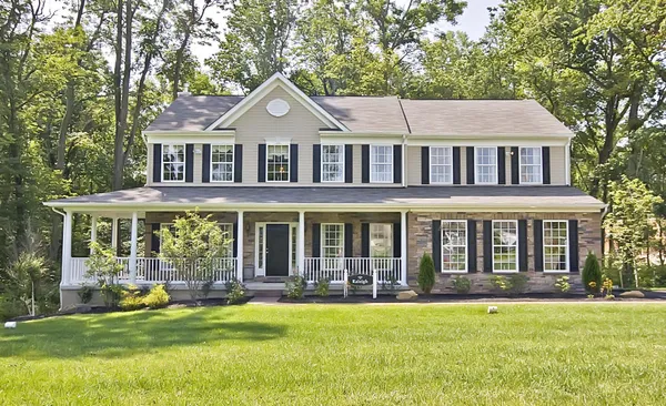 a front view of a house with a yard balcony and swimming pool