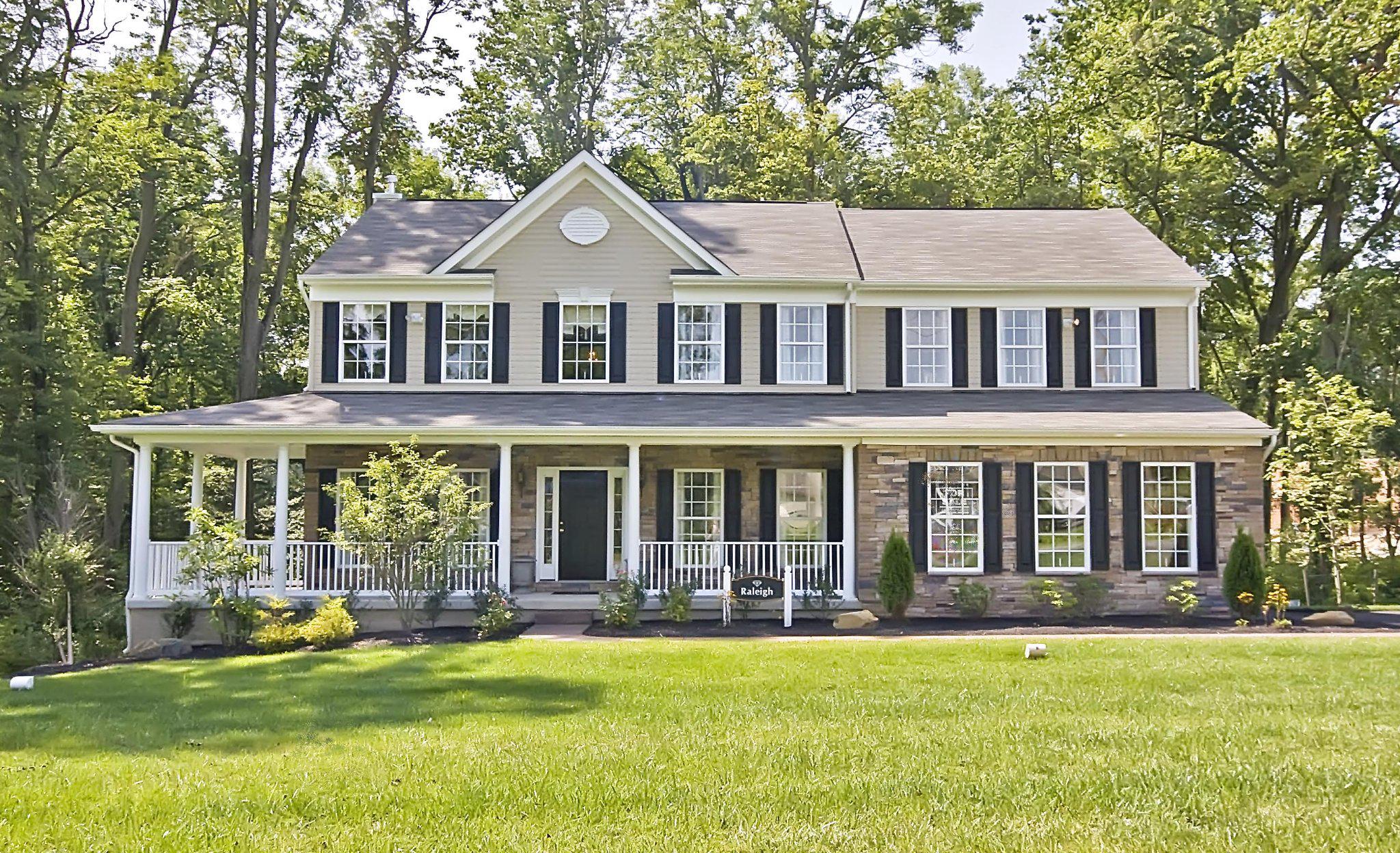 a front view of a house with a yard balcony and swimming pool