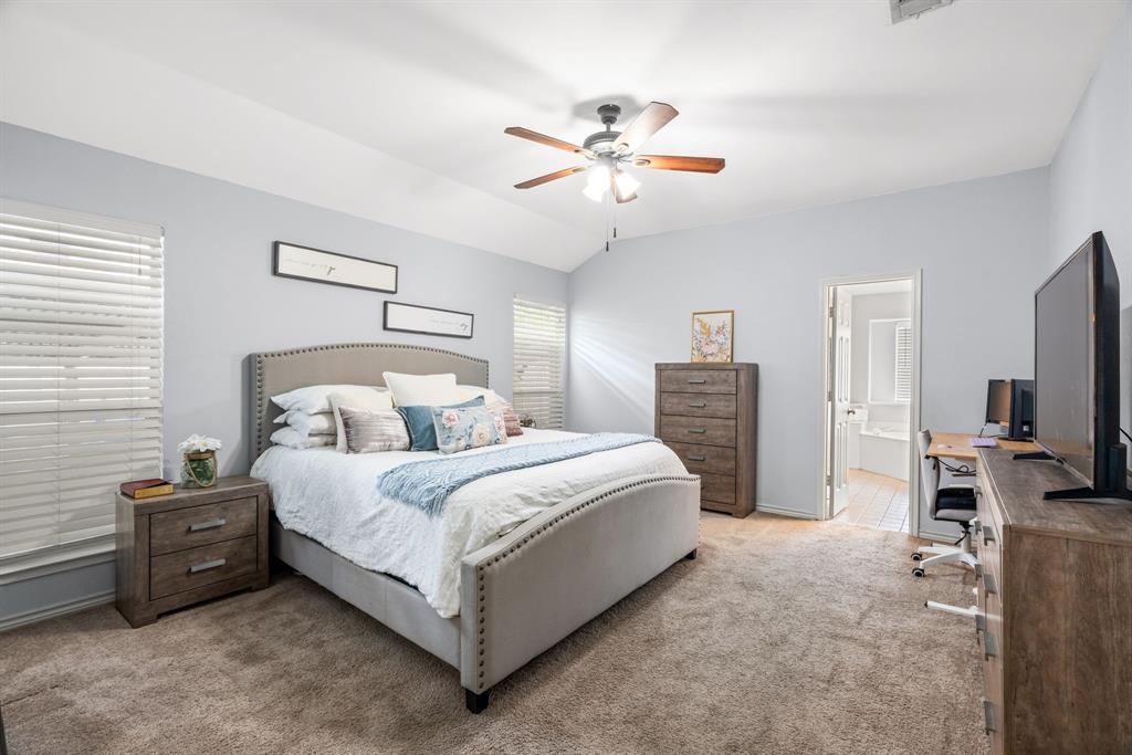 2302 Randi Road Rowlett, TX 75088 - Photo 14 of 33 a bedroom with bed and a flat tv screen on dresser