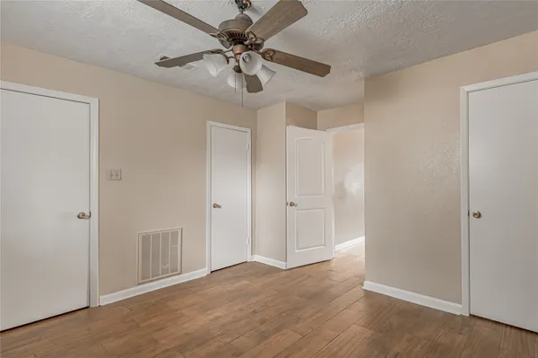 a view of an empty room and wooden floor