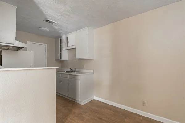 a kitchen with cabinets and a stove