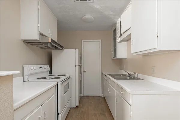 a utility room with cabinets washer and dryer