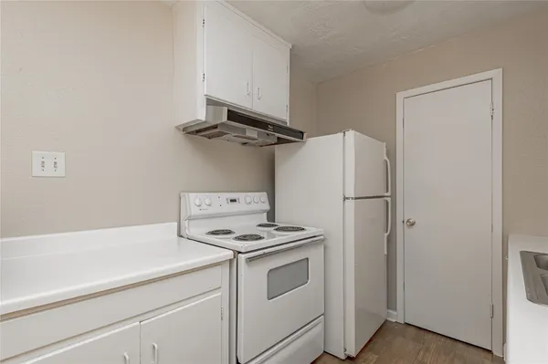 a kitchen with a stove and a refrigerator