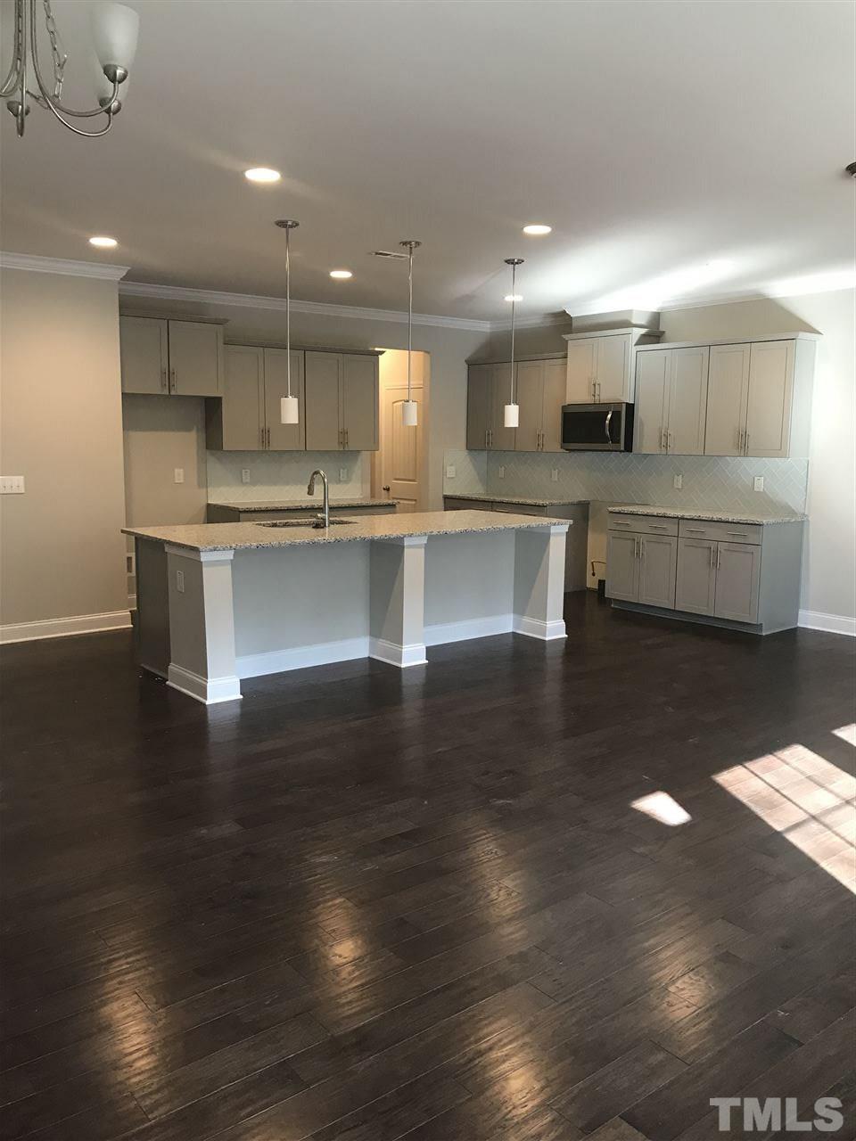 605 Newlyn Drive, Unit 59 Raleigh, NC 27606 - Photo 1 of 6 a large white kitchen with lots of counter space