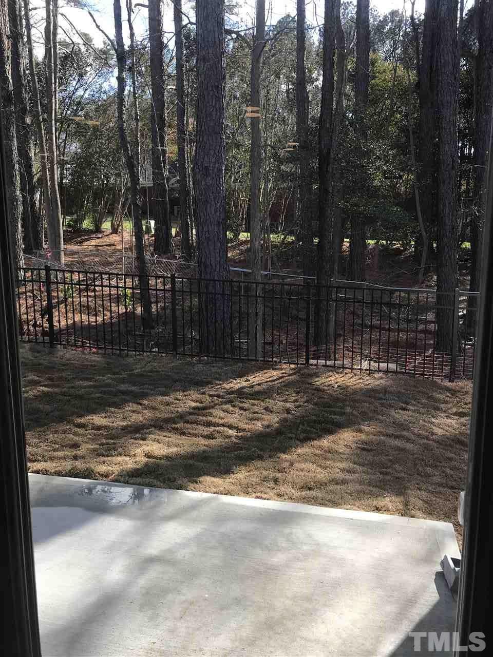 605 Newlyn Drive, Unit 59 Raleigh, NC 27606 - Photo 3 of 6 a backyard of a house with lots of green space and outdoor space