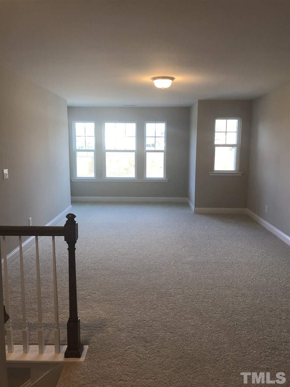 605 Newlyn Drive, Unit 59 Raleigh, NC 27606 - Photo 5 of 6 a view of empty room with windows