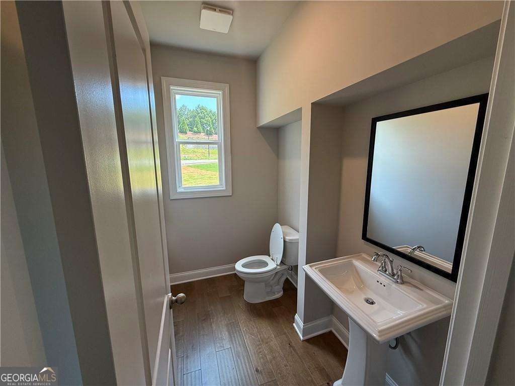 352 Lakeside Drive Canton, GA 30115 - Photo 4 of 16 a bathroom with a toilet sink and mirror