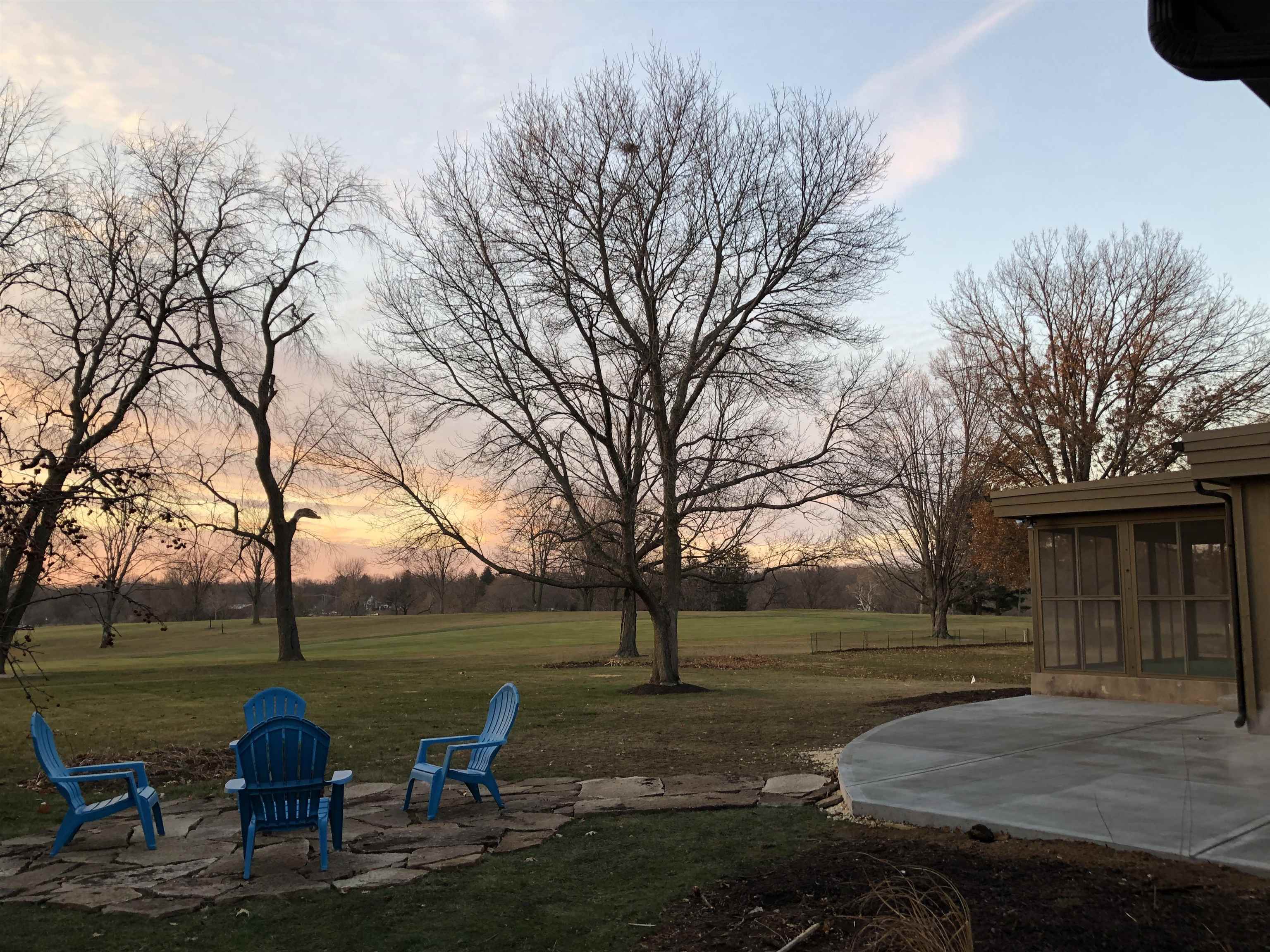 1158 Roxbury Road Rockford, IL 61107 - Photo 41 of 43 a view of a lake with table and chairs and large trees