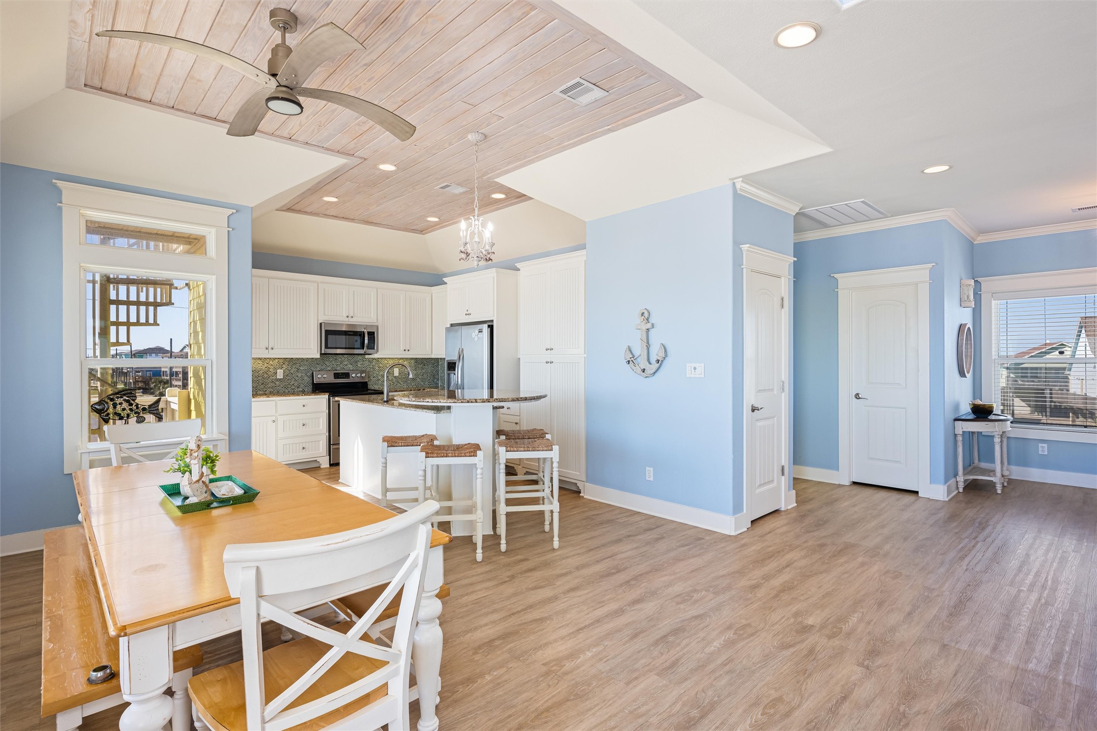 804 Eastview Crystal Beach, TX 77650 - Photo 11 of 50 a view of a dining room with furniture and wooden floor