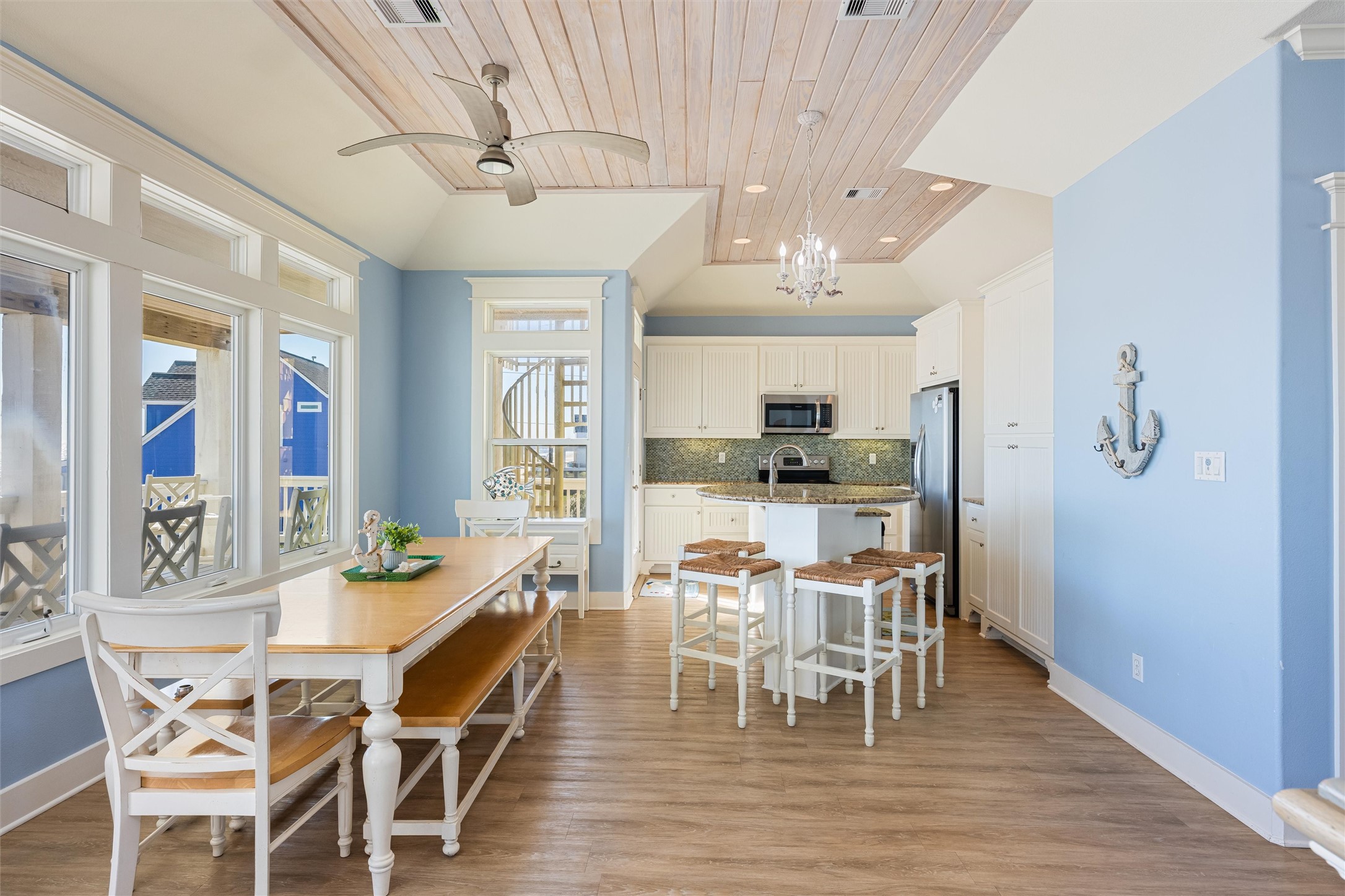 804 Eastview Crystal Beach, TX 77650 - Photo 12 of 50 a view of a dining room with furniture a chandelier and wooden floor