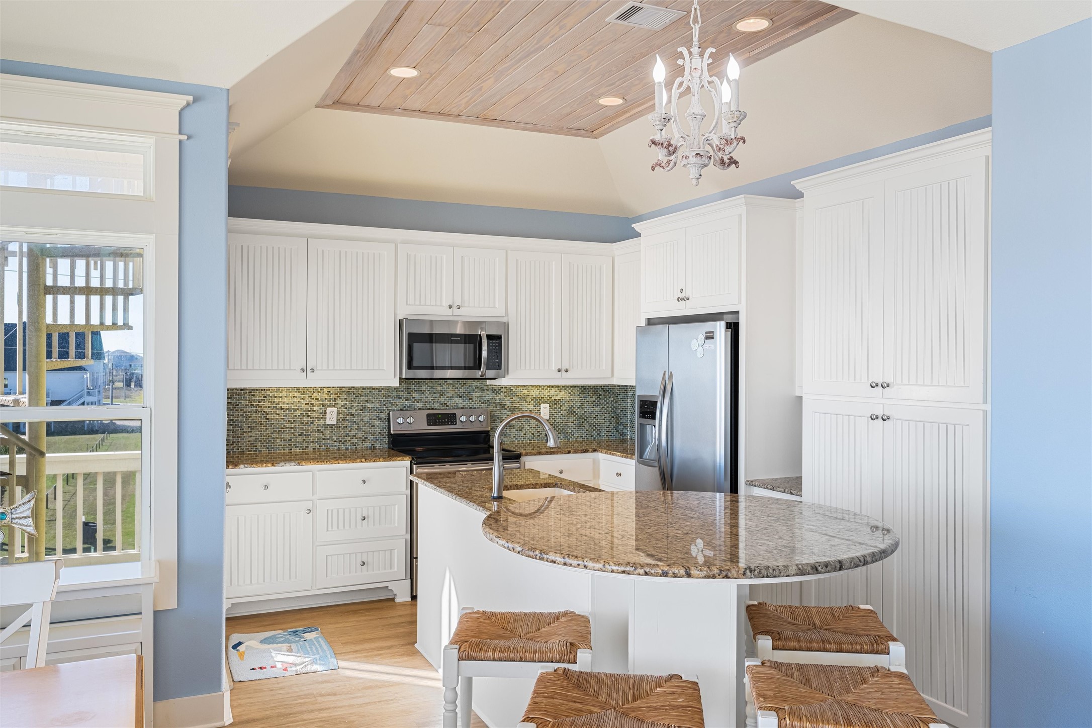 804 Eastview Crystal Beach, TX 77650 - Photo 13 of 50 a kitchen with kitchen island granite countertop a sink and refrigerator