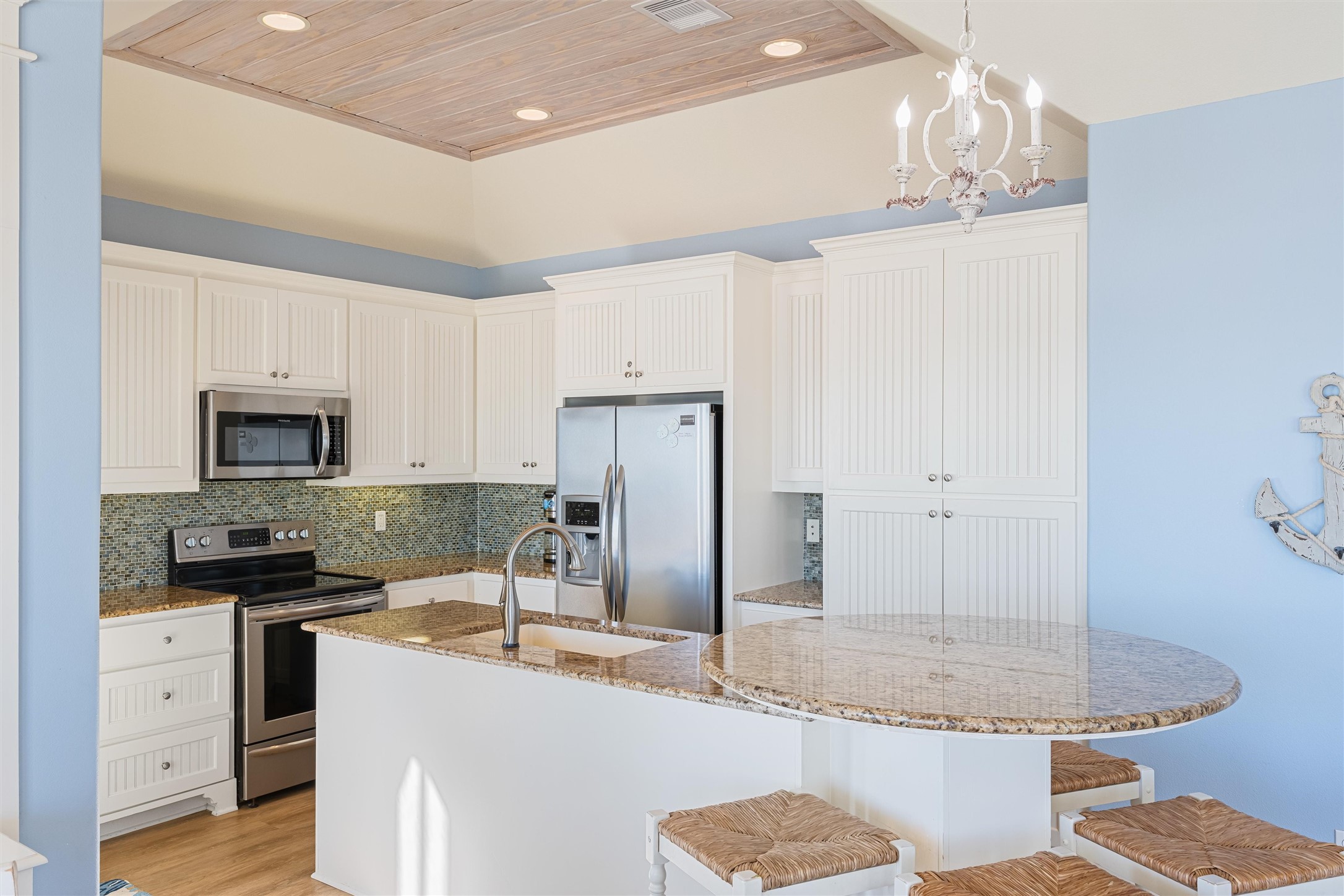 804 Eastview Crystal Beach, TX 77650 - Photo 14 of 50 a kitchen with stainless steel appliances granite countertop a sink stove and refrigerator