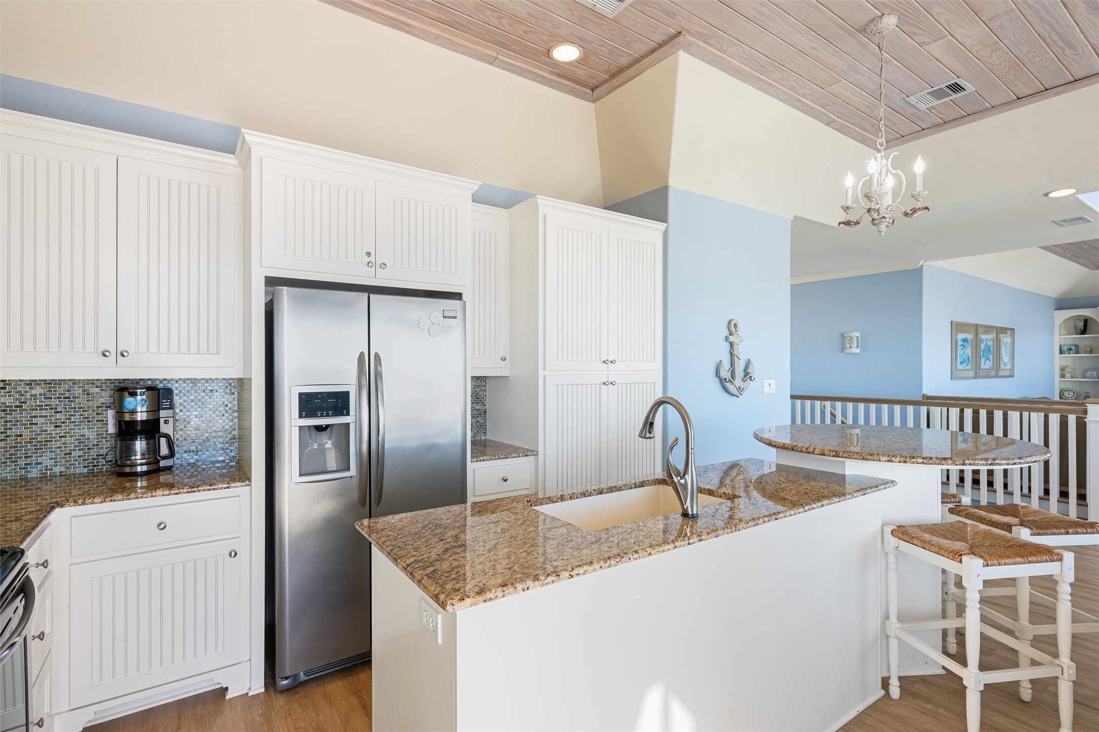 804 Eastview Crystal Beach, TX 77650 - Photo 16 of 50 a kitchen with stainless steel appliances granite countertop a sink refrigerator and cabinets