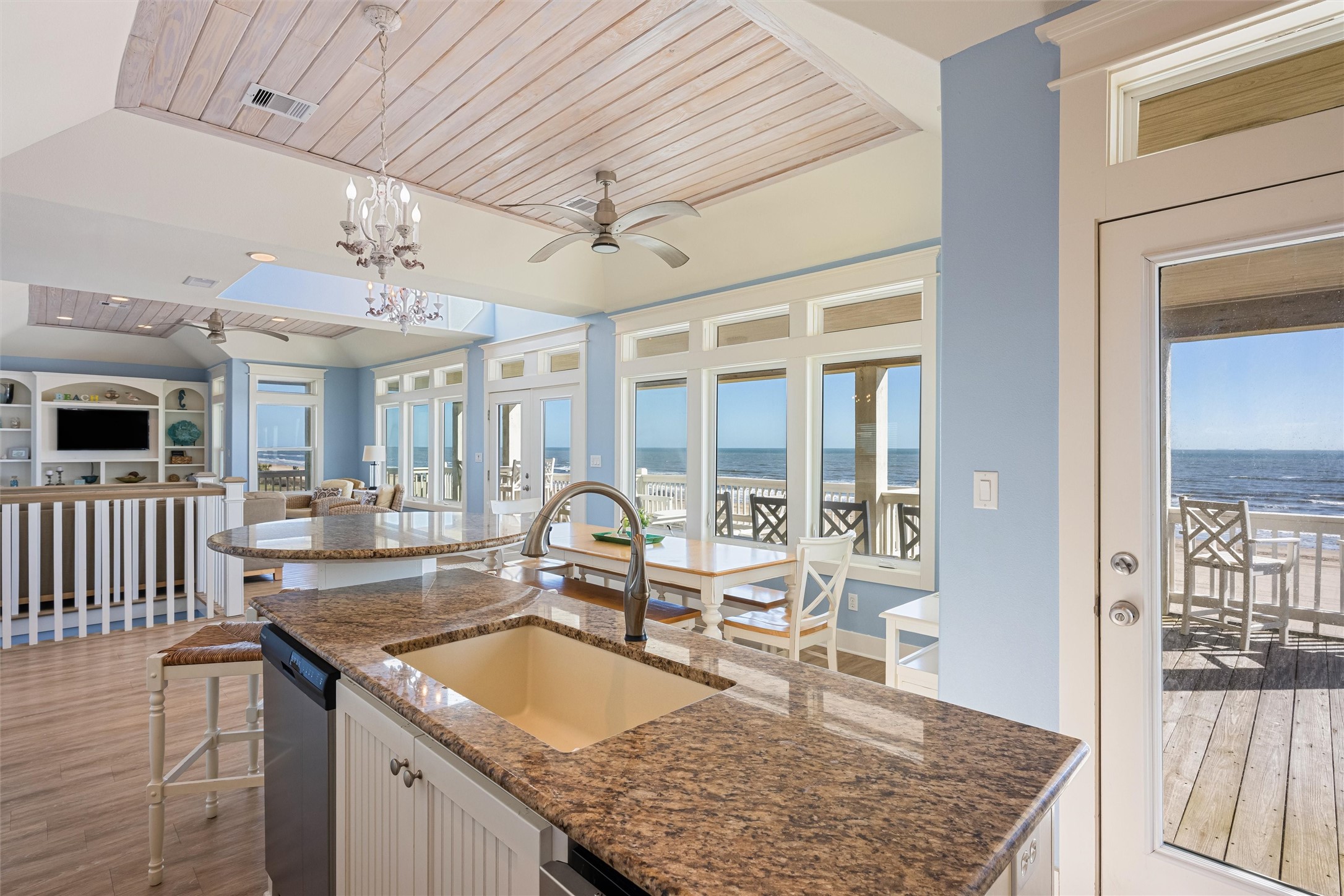 804 Eastview Crystal Beach, TX 77650 - Photo 18 of 50 a large kitchen with granite countertop a sink and a wooden floor