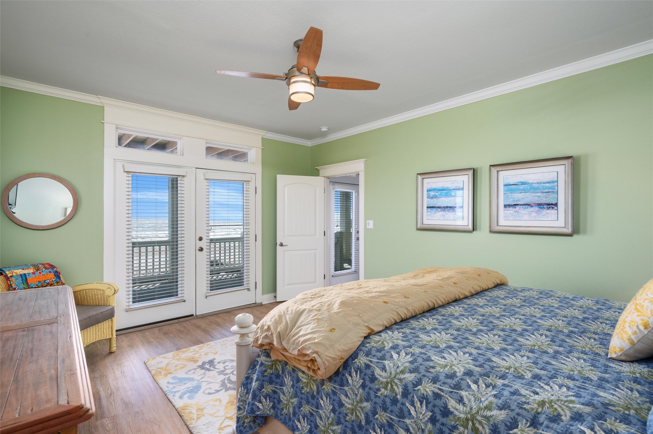 804 Eastview Crystal Beach, TX 77650 - Photo 34 of 50 a bedroom with a large bed and a chandelier