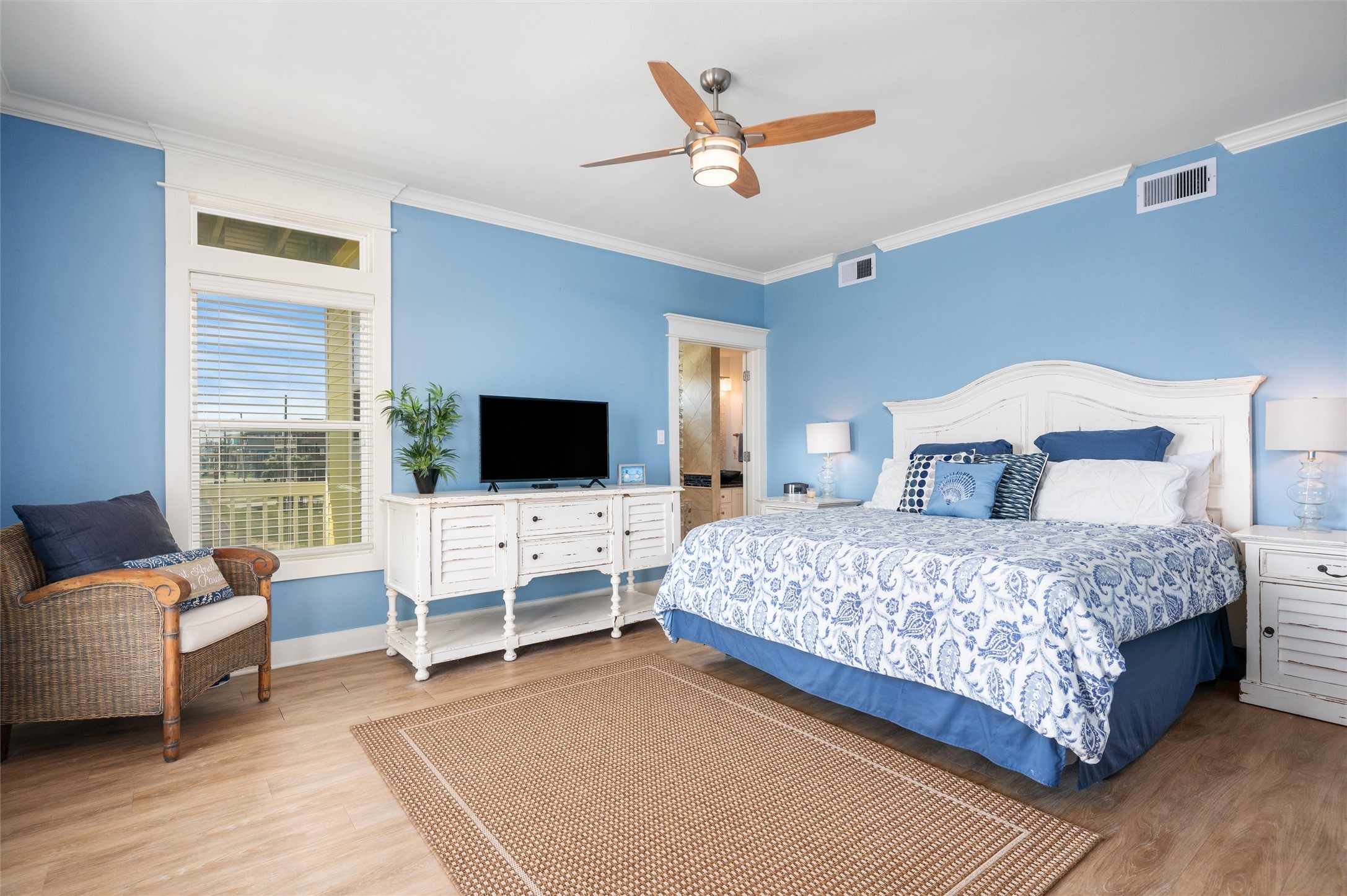 804 Eastview Crystal Beach, TX 77650 - Photo 38 of 50 a bedroom with a bed a couch and a flat screen tv