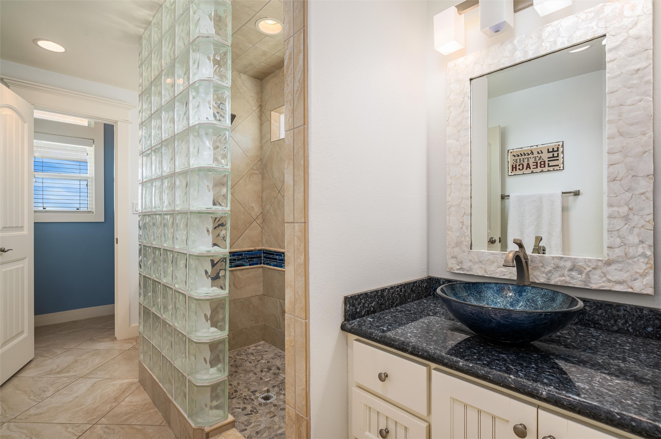 804 Eastview Crystal Beach, TX 77650 - Photo 40 of 50 a bathroom with a granite countertop sink a mirror and shower
