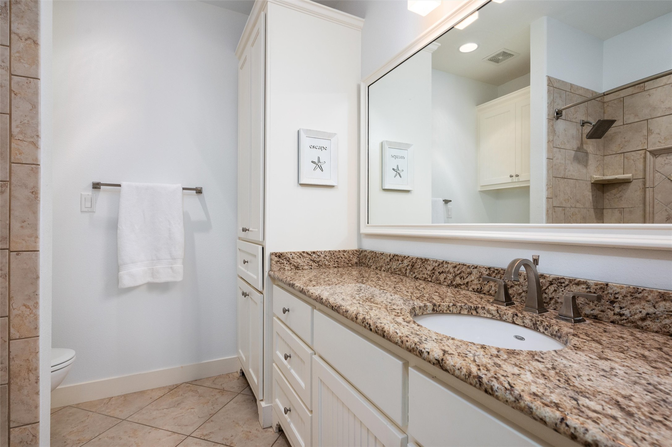 804 Eastview Crystal Beach, TX 77650 - Photo 45 of 50 a bathroom with a granite countertop sink and a mirror