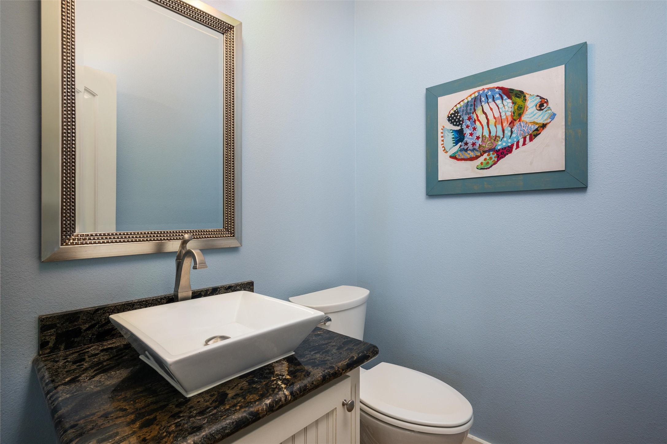804 Eastview Crystal Beach, TX 77650 - Photo 47 of 50 a bathroom with a toilet a sink and mirror