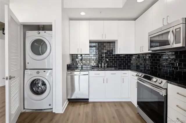 a kitchen with a refrigerator and a stove top oven