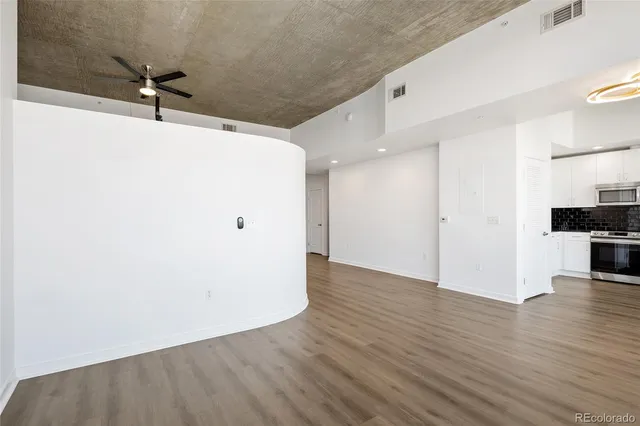 a view of a kitchen with a sink and a refrigerator