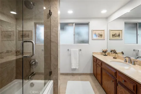 a bathroom with a double vanity sink and a mirror